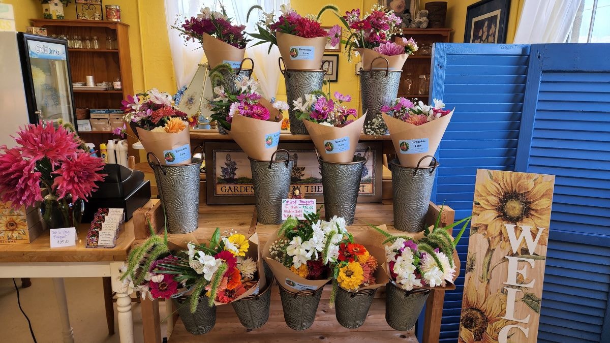 Colorful bouquets in galvanized buckets at a farmers market